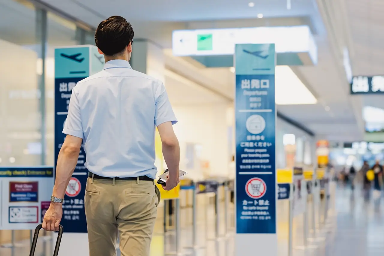 空港の搭乗口へ向かうビジネスマン